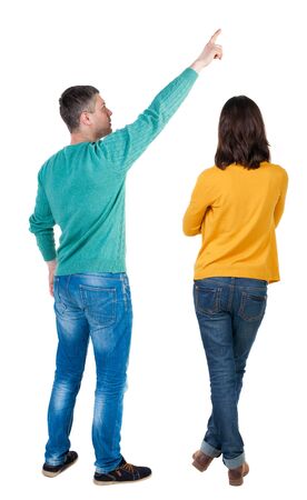 Back view of couple in sweater pointing. Rear view people collection. backside view of person. Isolated over white background.の写真素材