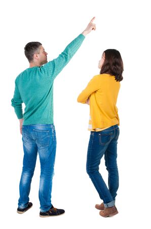 Back view of couple in sweater pointing. Rear view people collection. backside view of person. Isolated over white background.の写真素材