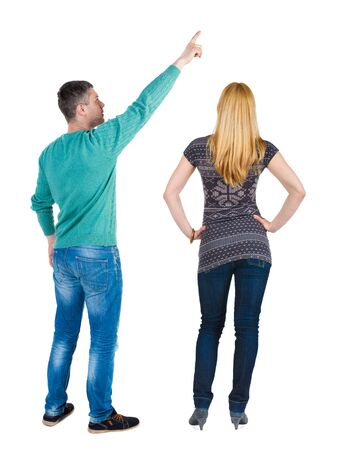 Back view of couple in sweater pointing. Rear view people collection. backside view of person. Isolated over white background.の写真素材