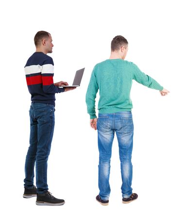 Back view two man in sweater with laptop. Rear view people collection. backside view of person. Isolated over white background. Guys looking forwardの写真素材