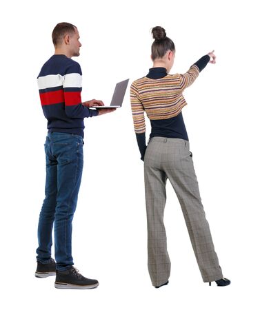 Back view couple with laptop in sweater. beautiful man and woman. Rear view people collection. backside view of person. Isolated over white background.の写真素材