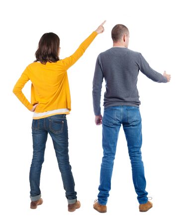 Back view of couple in sweater pointing. Rear view people collection. backside view of person. Isolated over white background.の写真素材