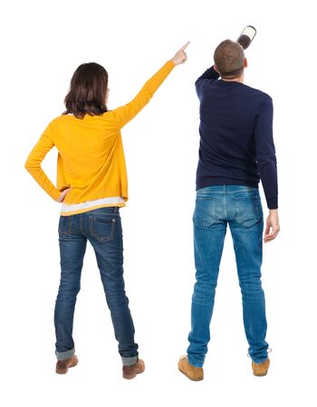 Back view of couple in sweater pointing. Rear view people collection. backside view of person. Isolated over white background.の写真素材