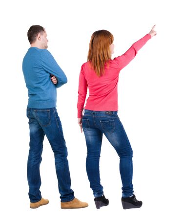 Back view of couple in sweater pointing. Rear view people collection. backside view of person. Isolated over white background.の写真素材