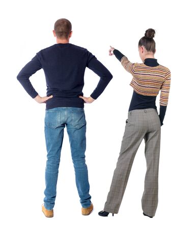 Back view of couple in sweater pointing. Rear view people collection. backside view of person. Isolated over white background.の写真素材