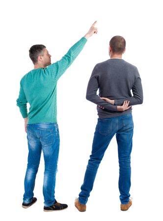 Back view of two man in sweater pointing. Rear view people collection. backside view of person. Isolated over white background. Guys stare aheadの写真素材
