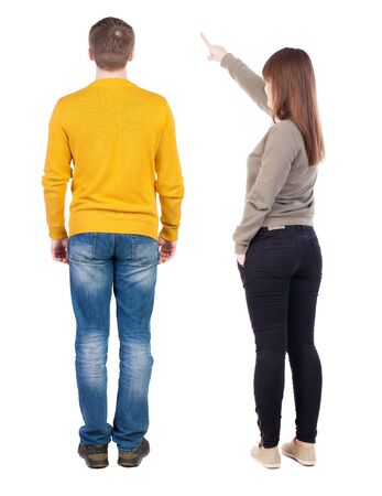 Back view of couple in sweater pointing. Rear view people collection. backside view of person. Isolated over white background.の写真素材
