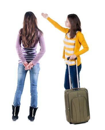 Back view of two woman in sweater traveling with suitcas. Back view. Rear view people collection. backside view of person. Isolated over white background.の写真素材