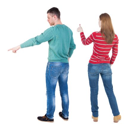 Back view of couple in sweater pointing. Rear view people collection. backside view of person. Isolated over white background.の写真素材