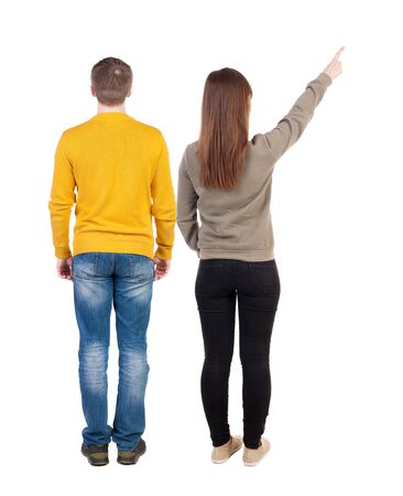 Back view of couple in sweater pointing. Rear view people collection. backside view of person. Isolated over white background.の写真素材