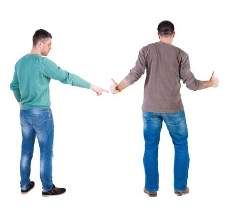 Back view of two man in sweater pointing. Rear view people collection. backside view of person. Isolated over white background. Guys stare aheadの写真素材