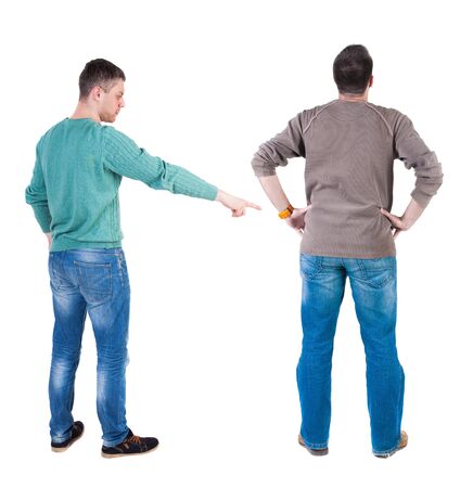 Back view of two man in sweater pointing. Rear view people collection. backside view of person. Isolated over white background. Guys stare aheadの写真素材