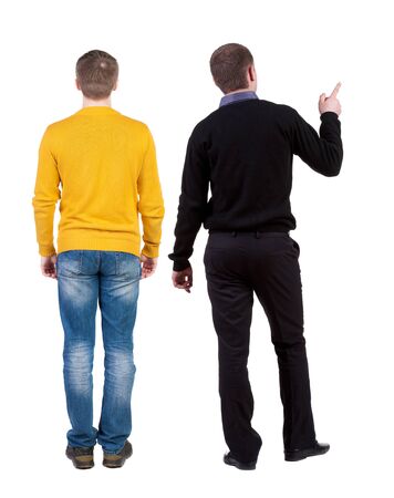 Back view of two man in sweater pointing. Rear view people collection. backside view of person. Isolated over white background. Guys stare aheadの写真素材