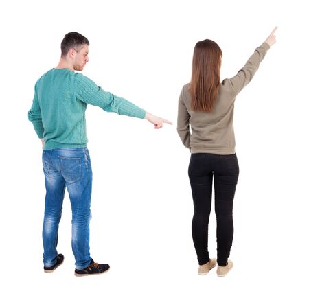 Back view of couple in sweater pointing. Rear view people collection. backside view of person. Isolated over white background.の写真素材