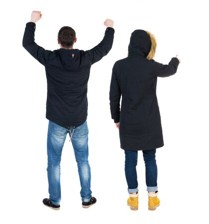 Back view of two pointing girl in winter jacket. Rear view people collection. backside view of person. beautiful woman friends showing gesture. Rear view. Isolated over white background.の写真素材