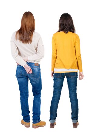 Back view of two woman in sweater. Rear view people collection. backside view of person. Isolated over white background. Girls are looking forwardの写真素材