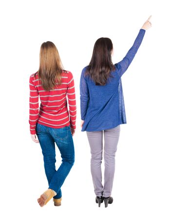 Back view of two pointing girl in sweater. Rear view people collection. backside view of person. beautiful woman showing gesture. Rear view. Isolated over white background.の写真素材