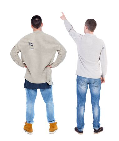 Back view of two man in sweater pointing. Rear view people collection. backside view of person. Isolated over white background. Guys stare aheadの写真素材