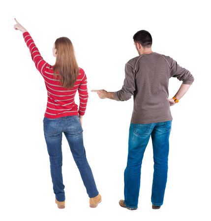 Back view of couple in sweater pointing. Rear view people collection. backside view of person. Isolated over white background.の写真素材