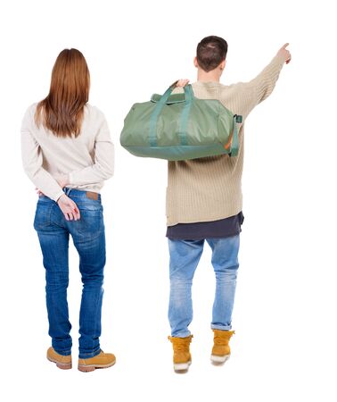 Back view of couple in sweater pointing. Rear view people collection. backside view of person. Isolated over white background.の写真素材