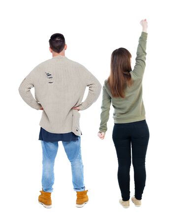 Back view of couple in sweater pointing. Rear view people collection. backside view of person. Isolated over white background.の写真素材