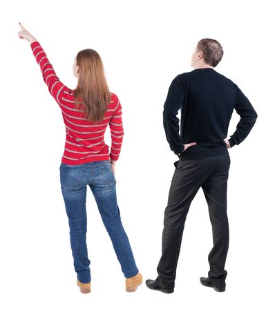 Back view of couple in sweater pointing. Rear view people collection. backside view of person. Isolated over white background.の写真素材