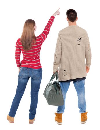 Back view of couple in sweater pointing. Rear view people collection. backside view of person. Isolated over white background.の写真素材