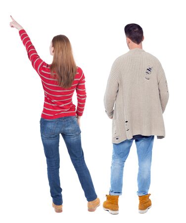 Back view of couple in sweater pointing. Rear view people collection. backside view of person. Isolated over white background.の写真素材