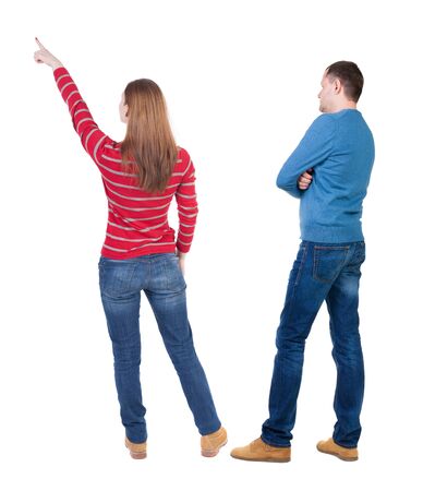 Back view of couple in sweater pointing. Rear view people collection. backside view of person. Isolated over white background.の写真素材