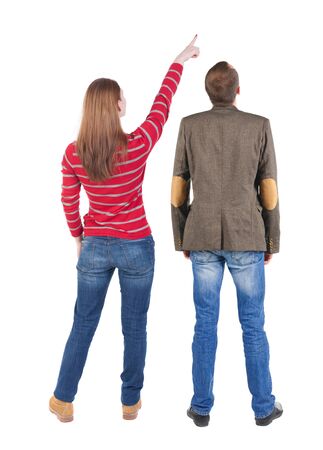 Back view of couple in sweater pointing. Rear view people collection. backside view of person. Isolated over white background.の写真素材