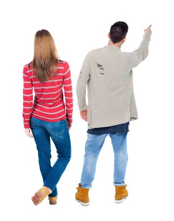 Back view of couple in sweater pointing. Rear view people collection. backside view of person. Isolated over white background.の写真素材