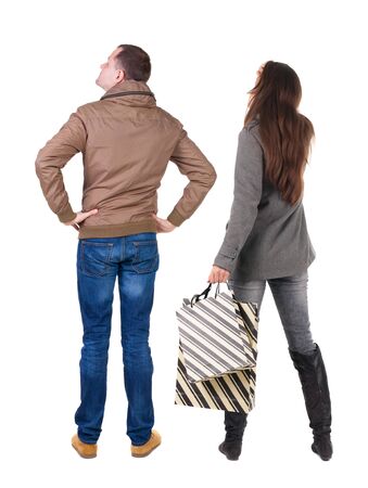 back view of couple with shopping bags in winter jacket. backside view of person. Rear view people collection. Isolated over white background.の写真素材