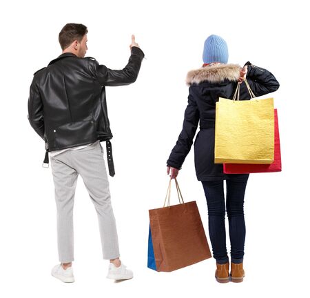 back view of couple with shopping bags in winter jacket. backside view of person. Rear view people collection. Isolated over white background.の写真素材