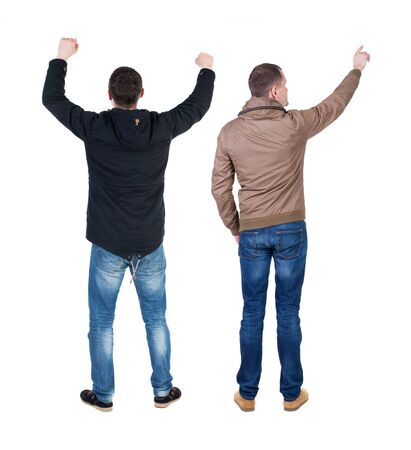 Back view of couple couple in winter jackets pointing. beautiful friendly girl and guy together. Rear view people collection. backside view of person. Isolated over white background.の写真素材