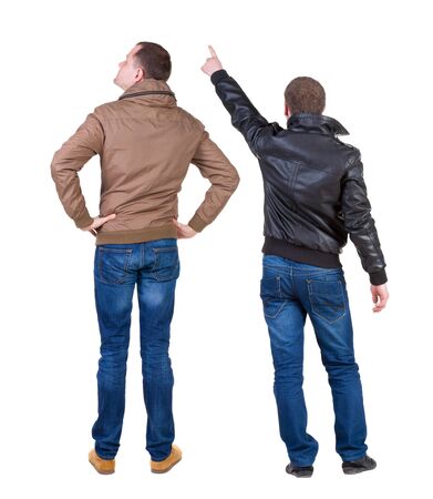 Back view of couple couple in winter jackets pointing. beautiful friendly girl and guy together. Rear view people collection. backside view of person. Isolated over white background.の写真素材