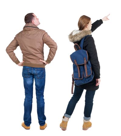 Back view of two pointing girl in winter jacket. Rear view people collection. backside view of person. beautiful woman friends showing gesture. Rear view. Isolated over white background.の写真素材