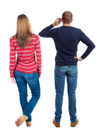 Back view of couple in sweater with mobile phone. beautiful friendly girl and guy together. Rear view people collection. backside view of person. Isolated over white background.の写真素材