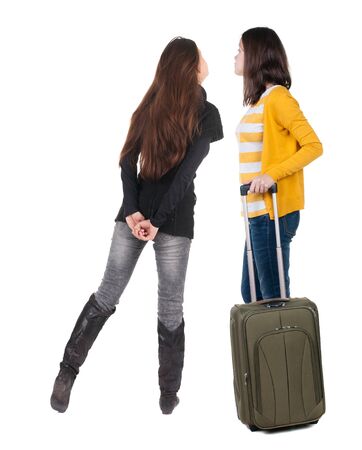 young couple in sweater traveling with suitcas. Back view. Rear view people collection. backside view of person. Isolated over white background.の写真素材