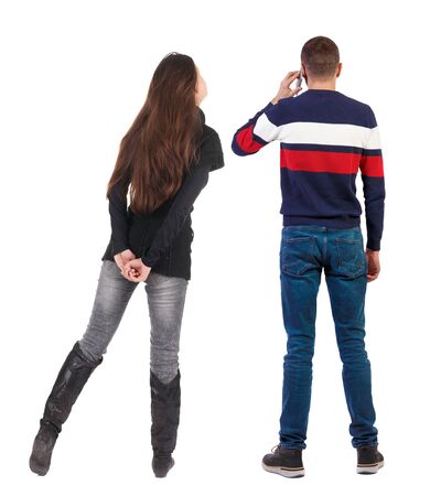 Back view of couple in sweater with mobile phone. beautiful friendly girl and guy together. Rear view people collection. backside view of person. Isolated over white background.の写真素材