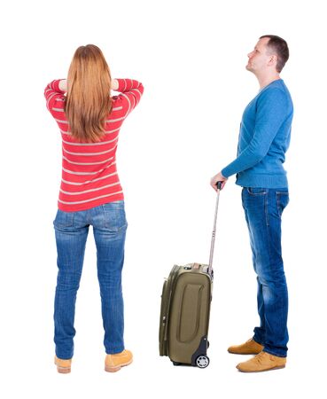 young couple in sweater traveling with suitcas. Back view. Rear view people collection. backside view of person. Isolated over white background.の写真素材