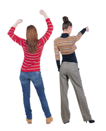 Back view of two pointing girl in sweater. Rear view people collection. backside view of person. beautiful woman showing gesture. Rear view. Isolated over white background.の写真素材