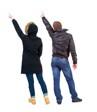Back view of two pointing girl in winter jacket. Rear view people collection. backside view of person. beautiful woman friends showing gesture. Rear view. Isolated over white background.の写真素材