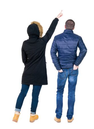 Back view of two pointing girl in winter jacket. Rear view people collection. backside view of person. beautiful woman friends showing gesture. Rear view. Isolated over white background.の写真素材