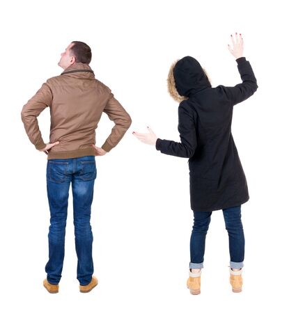 Back view of couple in winter jacket. beautiful friendly girl and guy together. Rear view people collection. backside view of person. Isolated over white background.の写真素材