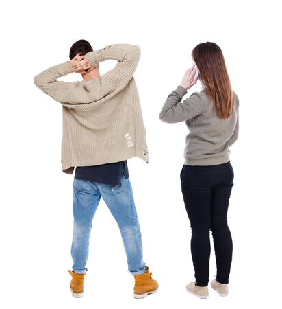 Back view of couple in sweater with mobile phone. Rear view people collection. backside view of person. Isolated over white background.の写真素材