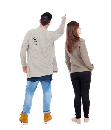 Back view of couple in sweater pointing. Rear view people collection. backside view of person. Isolated over white background.の写真素材