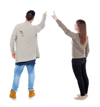 Back view of couple in sweater pointing. Rear view people collection. backside view of person. Isolated over white background.の写真素材