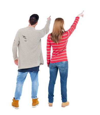 Back view of couple in sweater pointing. Rear view people collection. backside view of person. Isolated over white background.の写真素材