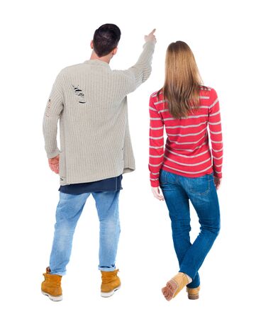 Back view of couple in sweater pointing. Rear view people collection. backside view of person. Isolated over white background.の写真素材