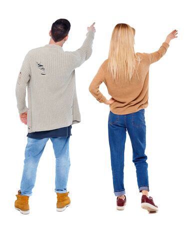Back view of couple in sweater pointing. Rear view people collection. backside view of person. Isolated over white background.の写真素材